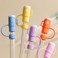 several different colored toothbrushes on sticks with snowflake designs and plastic handles