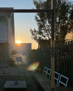 the sun is setting over an outdoor patio