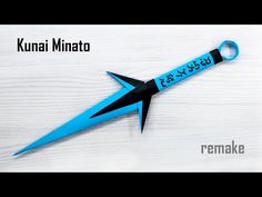 a blue and black scissors on top of a white table with the words kunai minato written in it