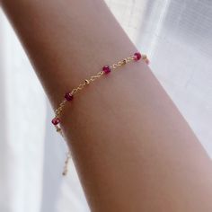 "* DETAILS* This dainty bracelet is a perfect gift to the one you love or to yourself. A nice every day bracelet. - AAA+ Natural Ruby Beads - 24k Gold Filled Chain - 14K GOLD FILLED Wire - 14k Gold Filled Spring Ring Clasp - 14k Gold Filled Link Rings - Bracelet has a 1\" Extension with gold filled ball charm. ✨All components are gold filled. 👉🏻For more birthstone bracelets, see https://www.etsy.com/shop/JinnysJewelryBySeJin You may also like 🌟Sapphire Bracelet. https://www.etsy.com/JinnysJew Delicate Beaded Bracelets With Birthstone As Gift, Delicate Bracelets With Tiny Beads, Dainty Bracelets For Birthday Gift, Adjustable Beaded Bracelet With Delicate Chain For Gift, Delicate Jubilee Beaded Bracelet As Gift, Dainty Chain Bracelet With Tiny Beads For Gift, Dainty Chain Bracelet With Tiny Beads As Gift, Dainty Everyday Crystal Bracelet, Dainty Jubilee Crystal Bracelet As Gift