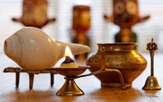 an assortment of decorative items on a wooden table, including a candle and other objects