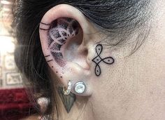 an ear tattoo with the word love written on it