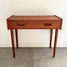 a wooden table with two drawers on it