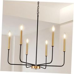 a black and gold chandelier with six candles hanging from it's center