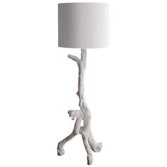 a white lamp with a tree branch on it