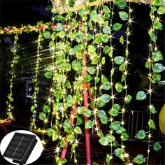 an outdoor decoration with green leaves and lights