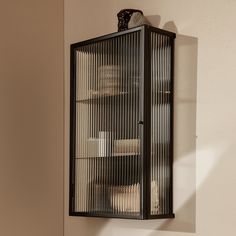 a bathroom with a metal cabinet and two soap dispensers on the wall