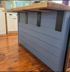 a kitchen island made out of an old wooden counter top with metal brackets on it