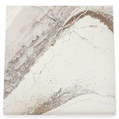 a white marble tile with brown and silver speckles on the bottom part of it