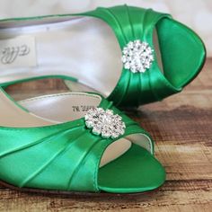 a pair of green wedding shoes with jeweled buckles