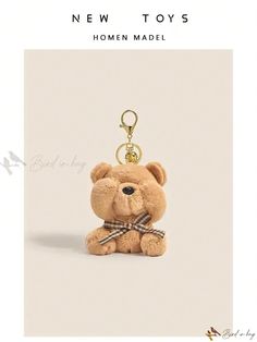 a brown teddy bear keychain with a bow tie on it's neck