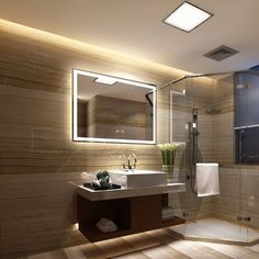 a bathroom with a sink, mirror and shower in it's corner area at night