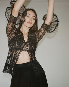 The Colette lace blouse features a delicate fitted V neckline top with ¾ sleeves and Venise lace collage all thru-out. The Colette comes with a lace bralette. Cotton and Rayon tulle lace Five satin buttons along bustline center front Dry clean only Each piece is made to order and handcrafted in our atelier. Slight variations may occur as each piece is unique. Fitted Lace Mesh Top With Lace Trim, Black Lace Party Tops, Black Lace Tops For Party, Lace Mesh Top With Lace Trim For Night Out, Sheer Lace Top For Party, Sheer Lace Top For Parties, Sheer Sleeves Lace Top For Night Out, Delicate Lace Top For Night Out, Party Mesh Top With Lace Trim