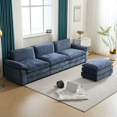 a living room with blue couches and white rugs