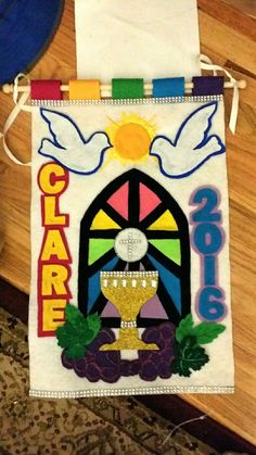 a banner hanging on the side of a wooden floor with an image of a chalice