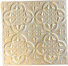 an intricately designed metal wall panel in gold and white, on a white background