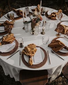 a table set with place settings and napkins