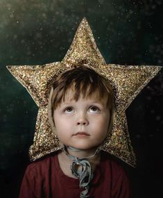 a young boy with a star on his head