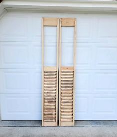 two wooden doors in front of a garage