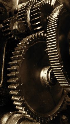 the gears of an old machine are shown in sepia