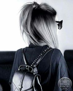 the back of a woman's head with sunglasses and a purse on her shoulder