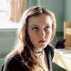 a woman sitting in front of a computer desk