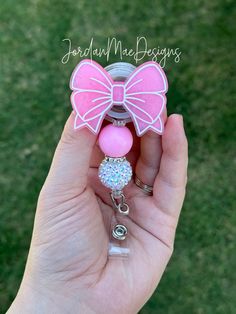 🎀 Face topper only- means you will only receive the pink bow top acrylic. No reel will come with it. You can glue it to your own reel or pop socket.  Such a beautiful HIGH QUALITY pink bow Badge Reel. This retractable badge holder is the best choice for ALL.  What a fun accessory to your scrubs, shirt pocket, belt loop, lanyard and more.  They make super fun and useful gifts for any person in any profession.  A great gift choice for nurses, medical staff, office staff, and anyone who is required to wear a badge! 💖If you are wanting a different color scheme message me! I can definitely do any color you want 💖 CARE:  - Please handle with care! - While the acrylic has been sealed for additional protection, please remember acrylics are fragile and can break if dropped or knocked against har Cheap Pink Badge Reel, Pink Plastic Craft Supplies For Gifts, Cute Pink Badge Reel For Birthday, Pink Bow Top, Beaded Badge Reel, Scrubs Shirt, Coquette Ribbon, Nursing School Notes, Office Staff