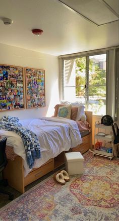 a bedroom with a bed, desk and window