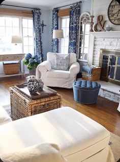 a living room filled with furniture and a fire place under a clock mounted on the wall