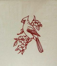 a red bird sitting on top of a white table cloth with flowers and leaves drawn on it