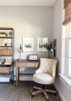 a room with a chair, desk and bookshelf in front of a window