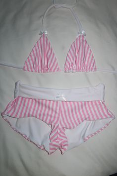 Your new favorite swim shorts are here.. <3 Low to mid rise fit white lining white bow detailing pink pinstripe pattern Styling & Fit Model wearing a size S Pair with the Candy Land Triangle Top for a complete look Fabric Nylon Spandex blend and lined Aftercare Hand wash in cold water and lay flat to dry Thank you for supporting my small business xx Caity Burdash Pink Pinstripe, Handmade Swimwear, Pinstripe Pattern, Swim Short, Cute Bathing Suits, Summer Swim Suits, Cute Swimsuits, Swim Skirt, Summer Set