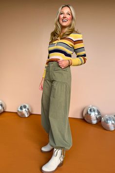 TRENDSETTER ALERT! Introducing our Olive Mid Rise Cinch Tie Ankle Balloon Style Pants. These pants not only feature a stylish and unique balloon style, but they also have a flattering mid-rise fit and a cute cinch tie detail at the ankles. Perfect for any fashion lover! We see our gal styling with a fitted tank or sleeveless sweater top and heels for a girl's night out or date night! Shop our collection of versatile TOPS and SHOES to create your cool girl vibe! Also comes in Rust. 100% Cotton In Khaki Wide Leg Pants With Elastic Waistband For Fall, Fall Wide Leg Khaki Pants With Elastic Waistband, Retro Cotton Bottoms For Fall, High Waist Cotton Parachute Pants For Fall, Green Parachute Pants With Elastic Waistband For Fall, Chic Cargo Style Parachute Pants, Chic Fall Cargo Style Parachute Pants, Chic Fall Cargo Parachute Pants, Trendy Green Parachute Pants For Fall