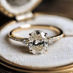 a close up of a diamond ring on a cloth