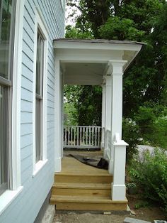 a porch with steps leading up to the front door