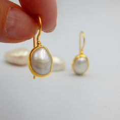 "White Fresh Water Baroque Pearl Drop Earrings. Sterling Silver 18k Gold Plated, 100% Handmade Unique Statement Earrings. PEARL: This enchanting June birthstone originates from oceans, lakes and rivers around the world. It is a timeless wardrobe staple, beloved by women of all ages. Pearls have long been associated with purity, humility and innocence. So it may be said that the June birthstone meaning is \"sweet simplicity.\" As such, pearls were traditionally given as a wedding gift. THE EARRIN Handmade Yellow Gold Pearl Earrings For Wedding, Gold High Luster Earrings For Wedding, High Luster Gold Earrings For Wedding, Hallmarked Dangle Pearl Earrings For Wedding, White Gold Plated Pearl Earrings For Wedding, Oval Gold Plated Earrings For Wedding, Teardrop Pearl Earrings For Wedding, Hallmarked, Gold Hallmarked Pearl Earrings For Wedding, Oval White Gold Pearl Earrings For Wedding