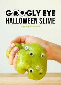 a hand holding an apple with googly eyes on it and the words googlely eye halloween slime