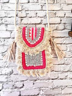 Pink and off white mobile sling bag beaded with stones and fringes on sides made of jacquard fabric . Bohemian Beaded Shoulder Bag For Summer, Summer Bohemian Beaded Shoulder Bag, Bohemian Beaded Shoulder Bag For Vacation, Bohemian Beaded Shoulder Bag For Beach, Bohemian Beaded Bags For Vacation, Bohemian Beaded Shoulder Bag For The Beach, Pink Bohemian Crossbody Shoulder Bag, Bohemian Pink Crossbody Shoulder Bag, Festival Beaded Beige Bags