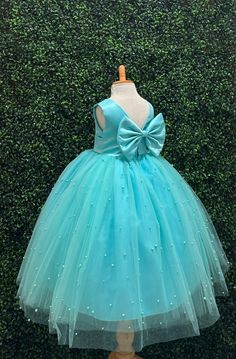 Our enchanting Ankle Length flower girl dresses are sure to turn heads! Bodice is made of Aqua Satin, waist consists of a matching sowed in sash (NOT DETACHABLE) The back of the dress has an open deep V-Back with a hidden zipper, followed by a detachable bow. The skirt has 4 tulle layers for fullness, the top layer of tulle consists of pearls. The dress has 2 layers of lining with crinoline. This dress is perfect for any occasion!  Dress Is Pictured with a petticoat NOT INCLUDED https://www.etsy Pageant Princess Dress With Satin Bow And Tulle, Pageant Princess Dress With Satin Bow, Pageant Tulle Ball Gown With Satin Bow, Turquoise Flower Girl Dress, Turquoise Dress, Turquoise Flowers, Toddler Girl Dresses, Big Bows, Birthday Flowers