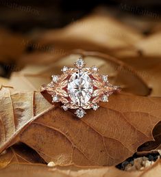 an engagement ring on top of a leaf