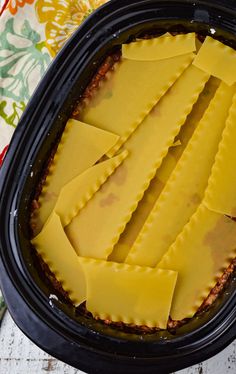 some slices of ravioli in a black crock pot