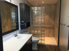 a bathroom with a toilet, sink and shower stall is shown in this image from the inside