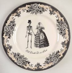 a black and white plate with a skeleton holding hands next to a woman in a dress