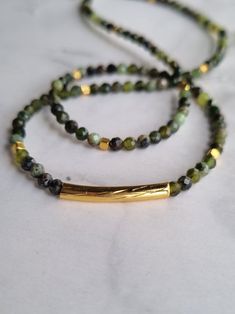 The dainty green jade necklace, adorned with Gold-filled tube, cube beads and faceted jade elements, is perfect for your mother, grandmother, daughter, sister, or yourself. This genuine natural jade choker is ideal for those who want to harness the power of jade gemstone. You will receive 1 necklace. 👀Discover Similar Dainty Jewelries https://www.etsy.com/shop/demetergemart/?etsrc=sdt§ion_id=44637022 ✨MATERIALS The gemstones are Faceted Jade. The tube and cube beads are 24k gold filled. The lob Rectangular Green Beaded Necklace For Gift, Green Rectangular Beaded Necklace Gift, Green Beaded Rectangular Necklace, Green Rectangular Beaded Necklace, Green Rectangular Gemstone Beads Jewelry, Jade Beaded Necklaces With Spacer Beads For Gift, Green Jade Necklaces With Spacer Beads, Green Jade Necklace With Spacer Beads, Jade Choker