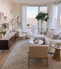 a living room filled with furniture and a large window covered in cityscape behind it