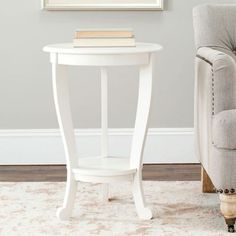 a small white table with a book on top