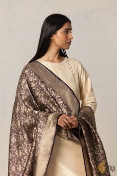 "This rich and luxurious Shikaargah dupatta is certain\u00a0to make a statement.\u00a0A beautiful handloom masterwork\u00a0to capture joyfulness on silk\u00a0with regal bird motifs in a landscape of vines.\u00a0\n\u00a0\n\n\n Color - A stunning shade of Deep Plum\n\n Technique\u00a0- Classic handwoven Banarasi art passed down through generations of weavers.\n\n Fabric\u00a0- Soft as butter, pure Katan silk\n\n Speciality\u00a0-\u00a0With a melange of motifs of birds, animals, flora and fauna, Shikaargah is a testament to the skill of our weavers and the wonders\u00a0they are capable of. This is woven art and a Banarasi\u00a0masterpiece.\n\n Tilfi Promise\u00a0- Pure. Handloom. Banaras.\n\n\u00a0\n\nSince this product is handwoven, there might be slight irregularities. But don't you think t India Inspired, Woven Art, Deep Plum, Bird Motif, Katan Silk, Weaving Process, Weaving Art, Silver Screen, Culture Art