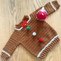 a knitted sweater with an apple on it