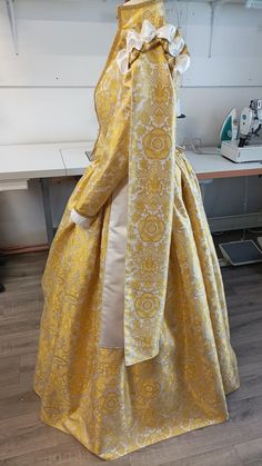 a dress made out of yellow and white fabric