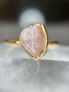 Rose Quartz works directly with the heart chakra to circulate divine love and heal emotional wounds and fears. It allows the user to reawaken the heart to self love, creating a greater sense of personal fulfillment and contentment as well as increasing one's ability to receive love. It is also beneficial for creative endeavors.  Each stone and ring is unique, just like you are so allow for variation in color and size. Your ring will come in a little box with the stone's properties included. Spiritual Rose Gold Promise Ring, Spiritual Style Rose Gold Ring, Spiritual Rose Gold Ring Jewelry, Rose Gold Spiritual Rings For Gift, Rose Gold Moonstone Open Ring Gift, Promise Ring With Rose Quartz And Gemstone Detail, Rose Quartz Crystal Ring For Promise, Rose Quartz Crystal Ring In Rose Gold, Spiritual Gemstone Stackable Promise Rings